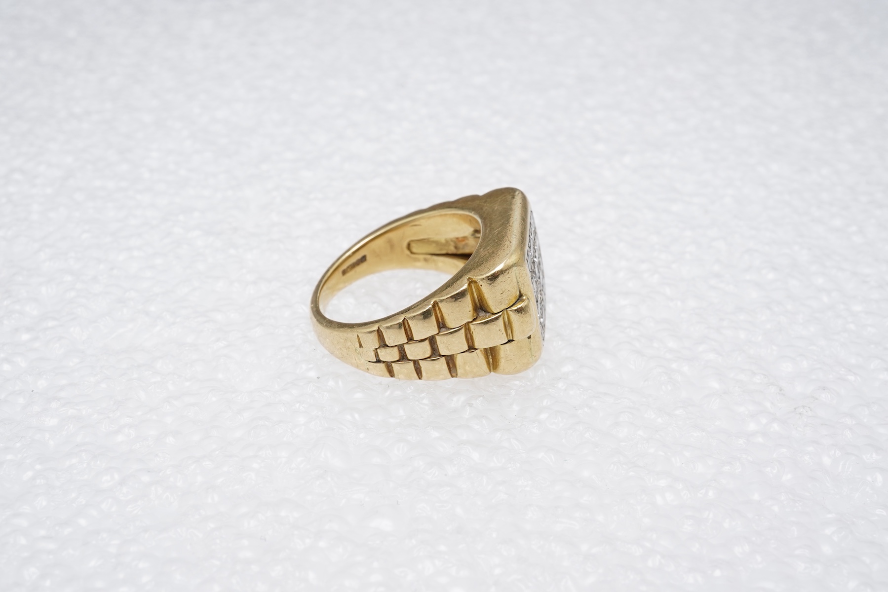A gold and diamond signet ring